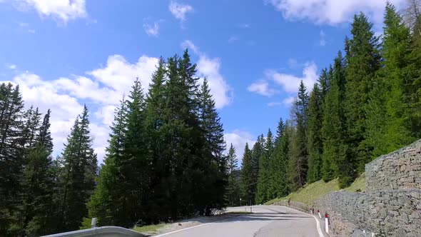 Speeding car on the serpentine in the Dolomites, Italy