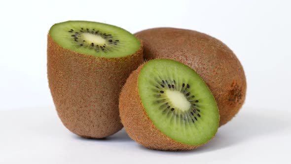 Whole Kiwi and Halfes Rotating on White Background