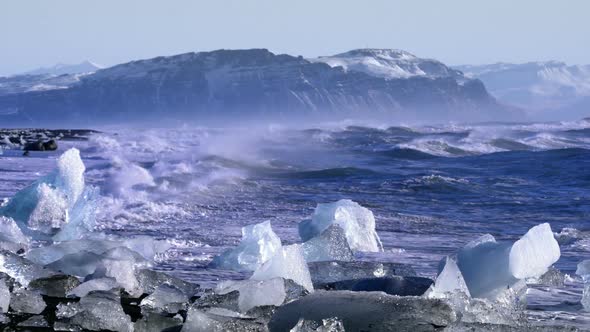 Ice From a Glacier Washing By Atlantic Ocean Waves on a Black Diamond Beach in Iceland