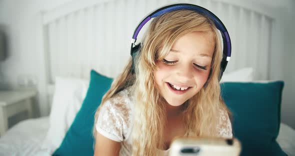 Girl in Headphones in Bed Closeup