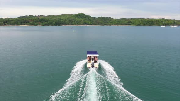 Aerial shot of a small Motor boat in the Indian Ocean off Madagascar from Behind in motion