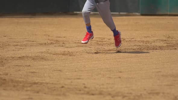 A boy runs to first base at little league baseball practice.