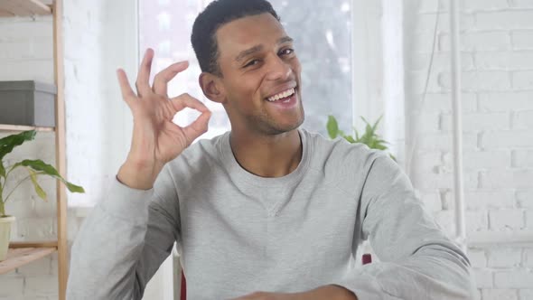 Portrait of AfroAmerican Man Gesturing Okay Sign Indoor