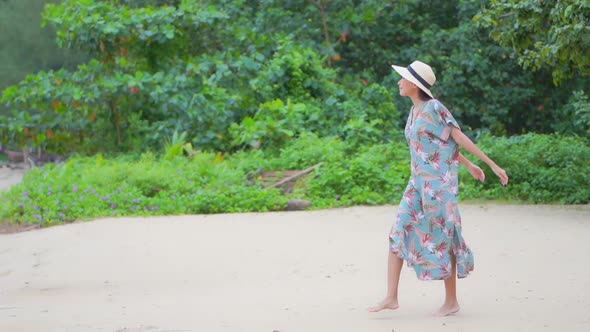 Asian woman enjoy around beautiful beach sea ocean