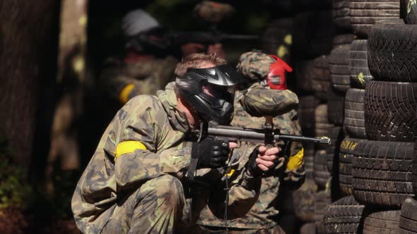 Paintball Sport Player Wearing Protective Mask Shooting