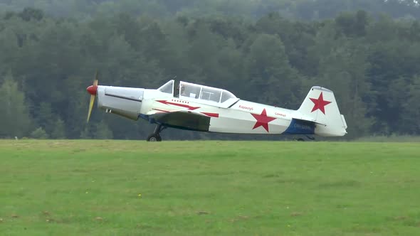 Single engine airplane on a grass runway.