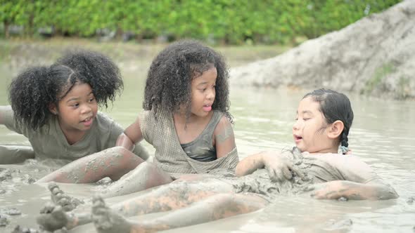 Children have fun playing in the mud in the community fields