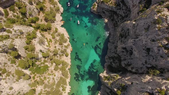 Aerial travel drone view of clear green water, cliffs of Cassis, Mediterranean Sea, Southern France.