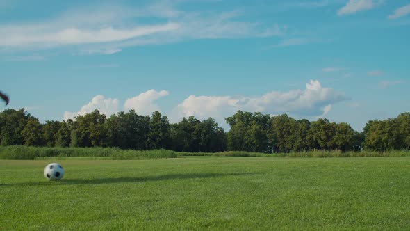 Happy Father and Son Playing Football on Field