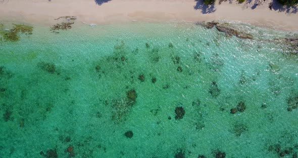 Tropical drone abstract shot of a sunshine white sandy paradise beach and blue ocean background in c