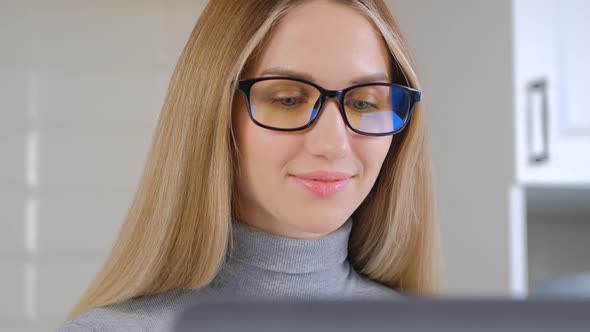 Beautiful blonde female using laptop computer for distant work on lockdown in 4k video