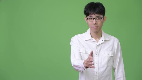 Young Asian Businessman Giving Handshake