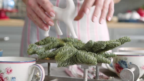 Christmas Table Decoration. Festive Table Setting. Female Hands Decorate the Table for Christmas