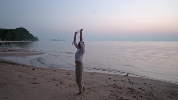 A Young Beautiful Girl on the Beach is Engaged in Poing