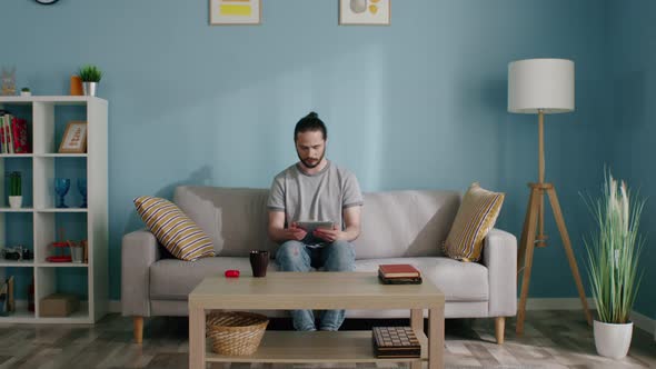 Isolated Man Uses Tablet Computer