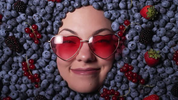 Happy Woman Face in Eyewear Fresh Ripe Berries  Blueberries Strawberries Currant