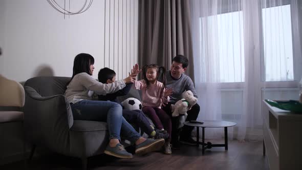 Happy Chinese Family with Children Playing at Home