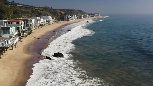 Aerial overview of scenic coastline of beautiful Carbon Beach in Malibu, California, USA at daytime.