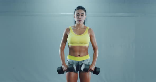 Woman with Strong Face Lifting Dumbbels
