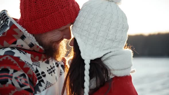 Happy Young Couple Dating and Kiss in Winter Outside at Xmas, Holidays Concept. Family Weekend Spend