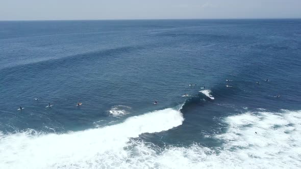 Group of Surfers Doing Surf Stunts and Enjoys Riding the Waves on Summer.