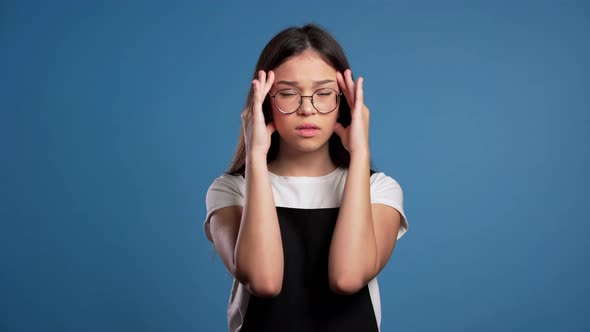 Young Asian Woman with Long Hair Having Headache, Studio Portrait. Girl Putting Hands on Head