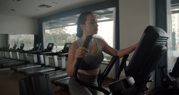 Young Indian Woman Working Out on a Treadmill in a Fitness Room