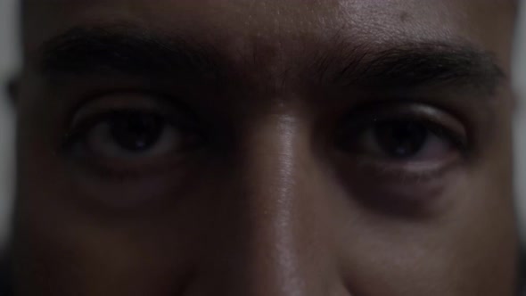 Adult UK Asian Male Looking Directly At Camera Pensively. Close Up, Locked Off