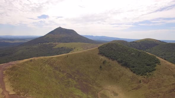 Aerial travel drone view of the Puy de Dome, lava dome volcano in France.