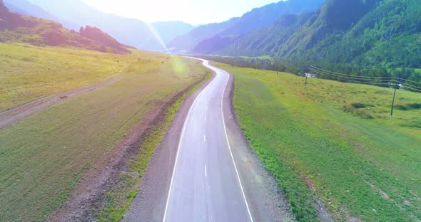 Flight Over Mountain Asphalt Highway Road and Meadow