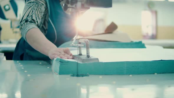 Pieces of Textile are Getting Cut Out with an Industrial Razor