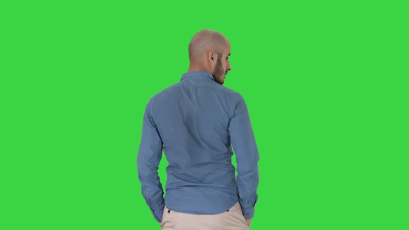 Arab in Casual Looking Around with Hands in Pockets on a Green Screen, Chroma Key