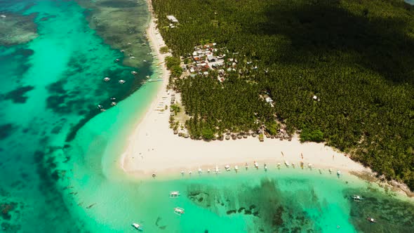 Tropical Daco Island with a Sandy Beach and Tourists