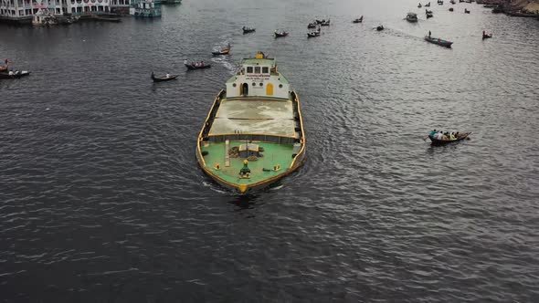 Aerial view of a Person carrying watermelons on boat along the Buriganga river.