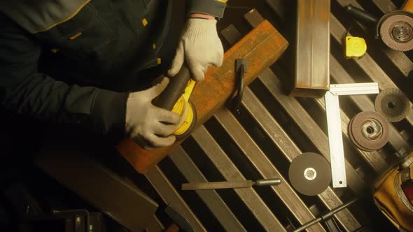 Worker polishing metal