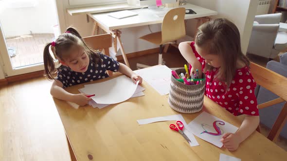 Little Girls Draw on Paper at Home During a Pandemic