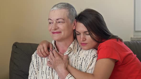 An Adult Daughter Hugs Her Mother