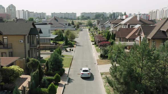 Establishing Shot of Cottage Township with Solar Photovoltaic Panels Arrays on the Roofs