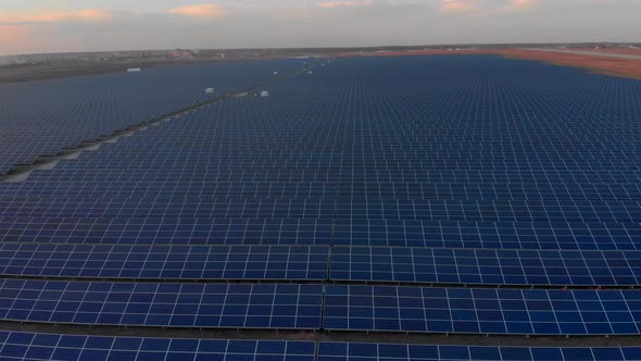 Aerial Drone View Into Large Solar Panels at a Solar Farm. Solar Cell Power Plants. Footage Video .