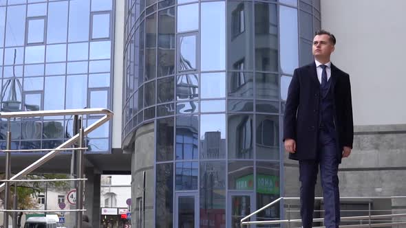 A Businessman in a Suit Walking Through the Business Center. Slow Motion