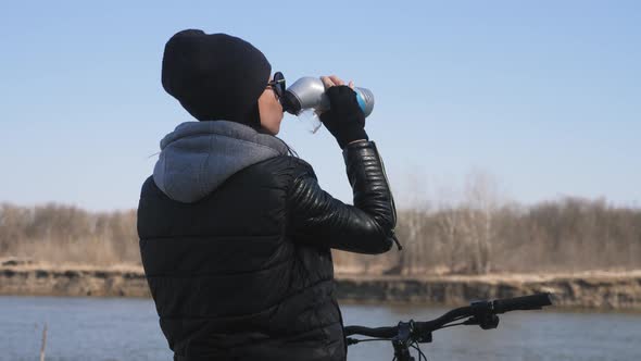 Girl on a Bicycle, Drinking Water From the Sport Bottle. Adventures and Active Lifestyle Concept.