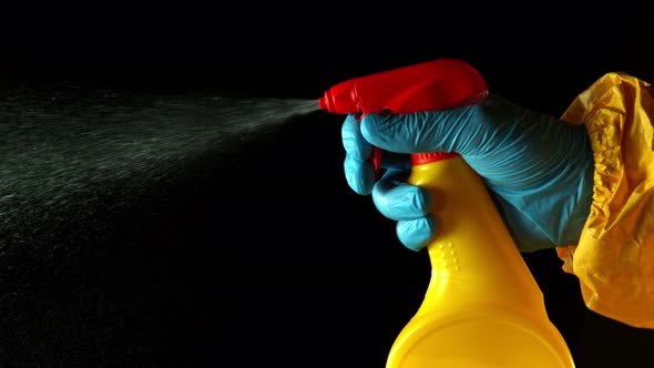 Super Slow Motion Shot of Human Spraying Disinfection on Black Background at 1000 Fps.