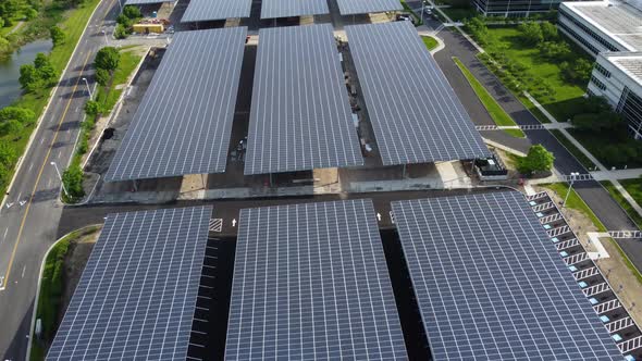 Solar panels installed in a corporate office complex parking lot and solar panels on the office comp