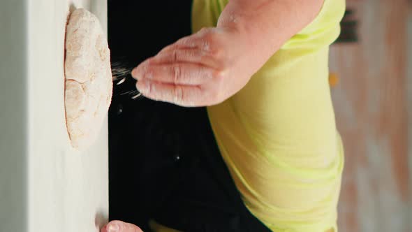 Vertical Video: Woman Is Occupied with Dough Preparation