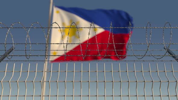 Barbed Wire Against Waving Flag of Philippines