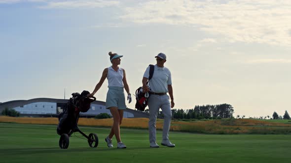 Couple Golf Players Discuss Sport Course Outside