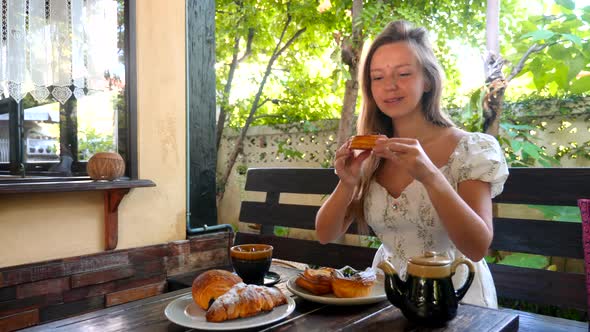 Woman in Outdoor Cafe Smell Fresh Bun Enjoy and Expects to Eat