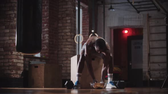 A Black Handsome Man Training in the Gym  Covering Hands in Chalk