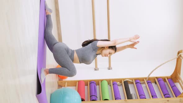 Girl Performs Exercises for Yoga in Gym Gymnastics