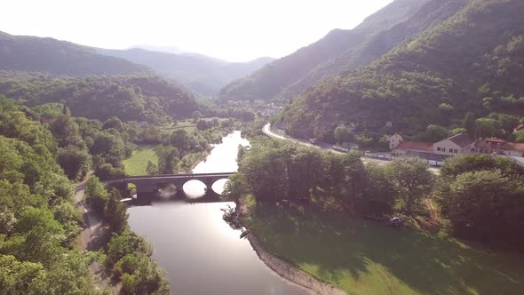 Drone View of the Embankment of the Crnojevica River Surrounded By Green Mountains